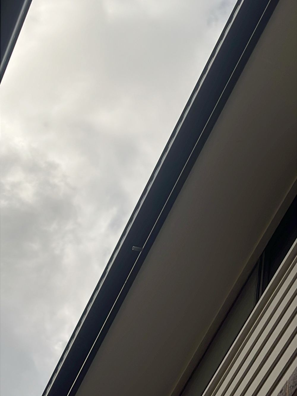 Air conditioner drain discharging onto the ground beside the house, Rouse Hill