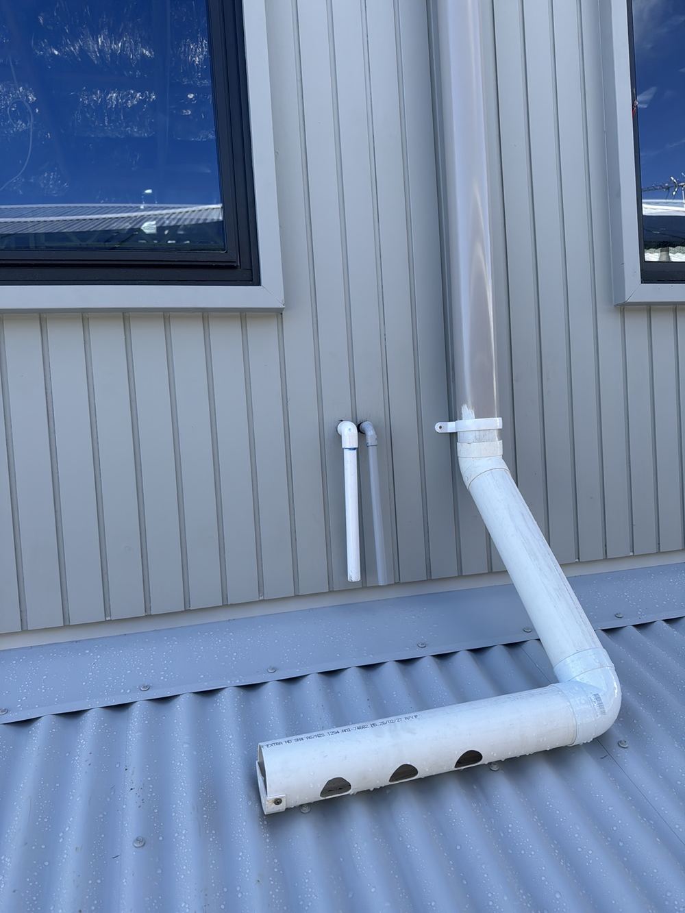 Air conditioner condensate draining onto roof flashing rather than an approved outlet, Rouse Hill