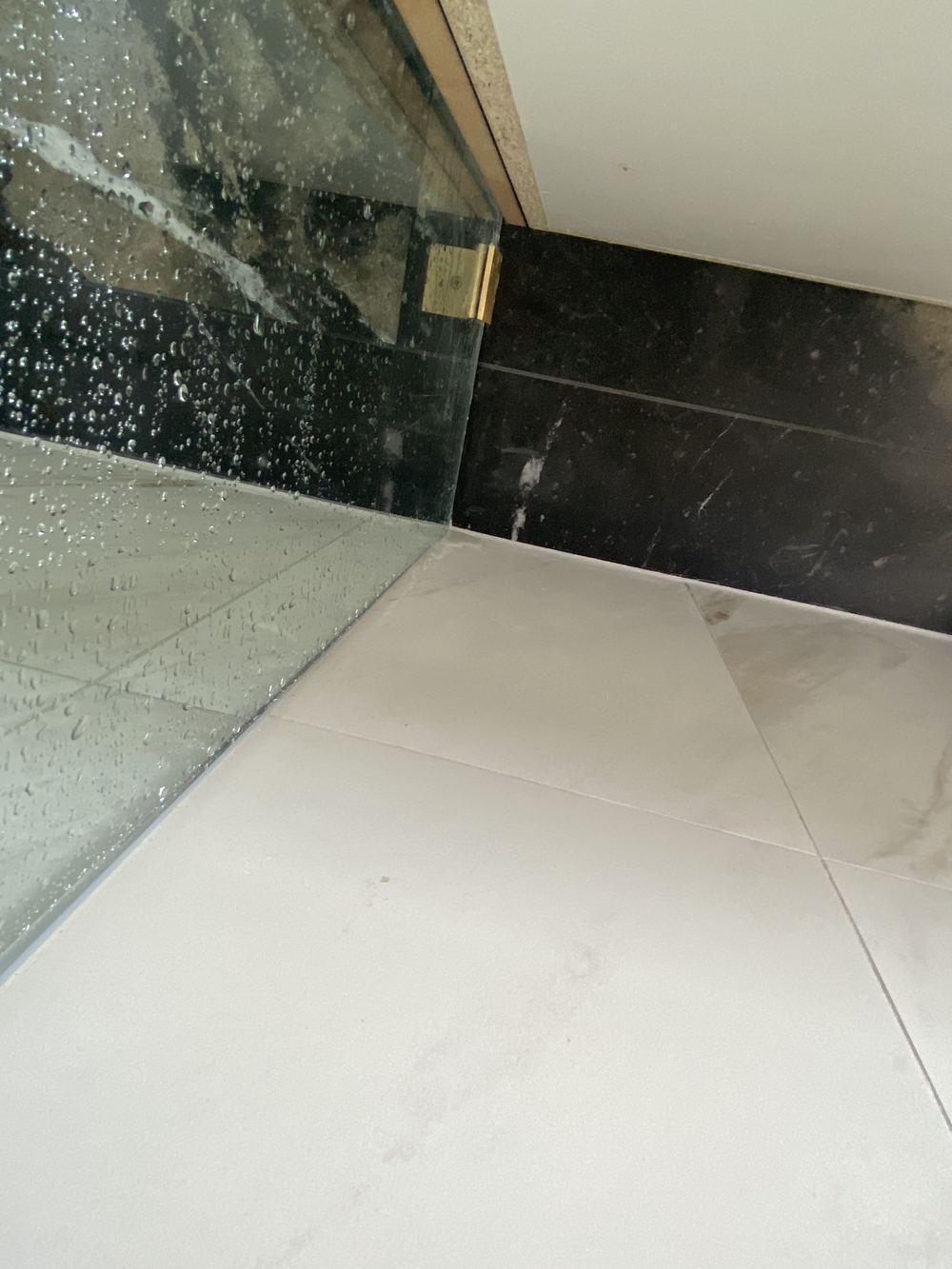 Water escaping under the shower screen onto the bathroom floor, Rouse Hill